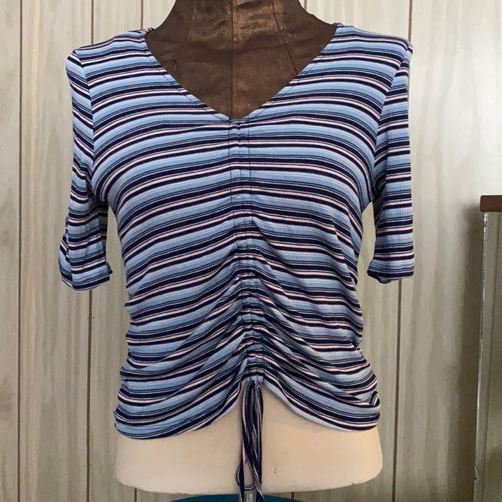 V-neck striped top gathers in front with ties. Sleeves are gathered.
